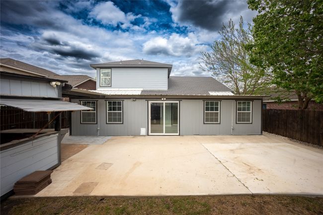 Back of house featuring fence, a patio, and roof with shingles | Image 17