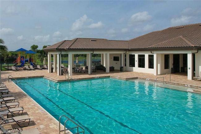 Community pool featuring a patio area and a playground | Image 27