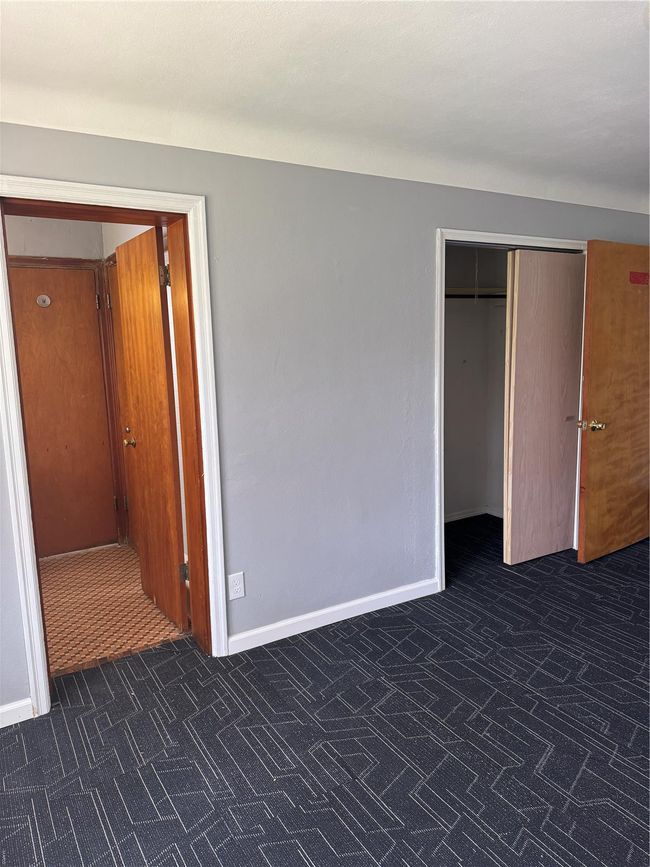 Unfurnished bedroom with a closet and baseboards | Image 5