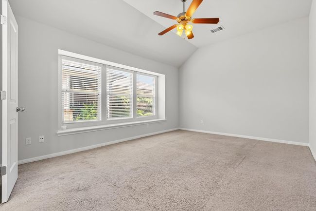 Primary bedroom featuring lofted ceiling, carpet floors, and ceiling fan | Image 16