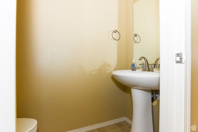 Half bathroom featuring baseboards and toilet | Image 18
