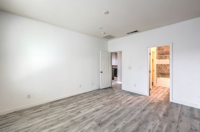 Unfurnished bedroom with light wood-style flooring, baseboards, and visible vents | Image 31