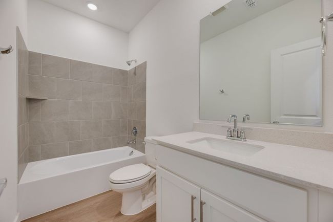 Full bathroom with vanity, wood finished floors, and tub / shower combination | Image 18