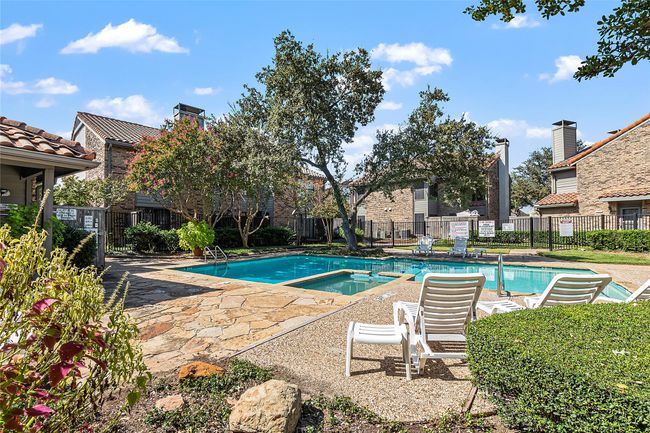 View of swimming pool with a patio and a pool with connected hot tub | Image 20