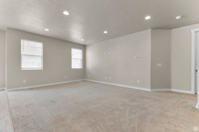 Spare room featuring light colored carpet, recessed lighting, and a textured ceiling | Image 13