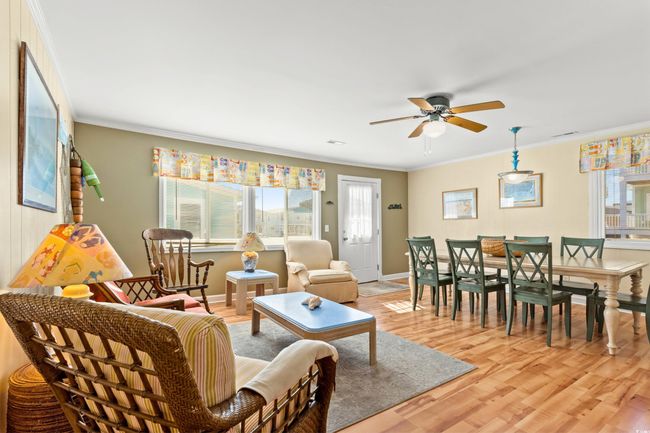 Living room with ceiling fan, light wood-type flooring, and crown molding | Image 6