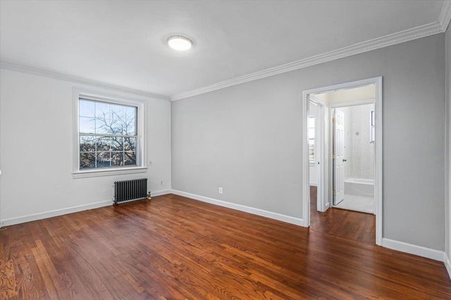 Living Room with radiator, crown molding, and dark hardwood / wood-style flooring | Image 5