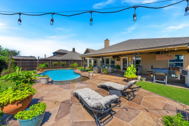 View of pool with a fenced backyard, a patio, and a ceiling fan | Image 35