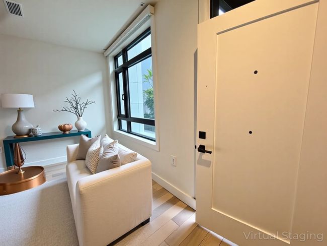 Entryway featuring baseboards, light wood finished floors, and visible vents | Image 25