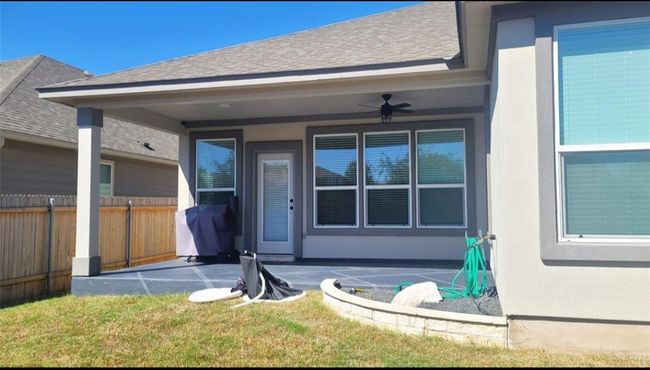 Entrance to property with a patio area, a shingled roof, ceiling fan, and stucco siding | Image 24
