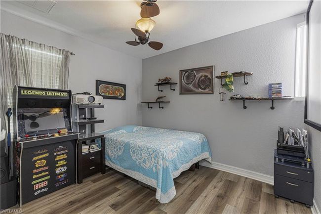 Bedroom featuring a ceiling fan, visible vents, wood finished floors, and baseboards | Image 13