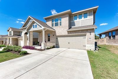 Expansive front porch with beautiful landscape + landscape lighting. | Image 3