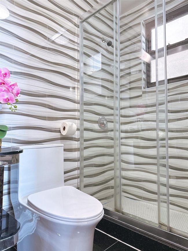 Bathroom with a stall shower and toilet | Image 8