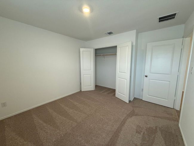 Unfurnished bedroom featuring carpet, baseboards, and a closet | Image 9