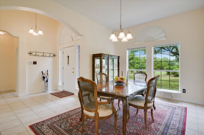A large window brings in natural light while offering views of the front yard and oak trees. | Image 11
