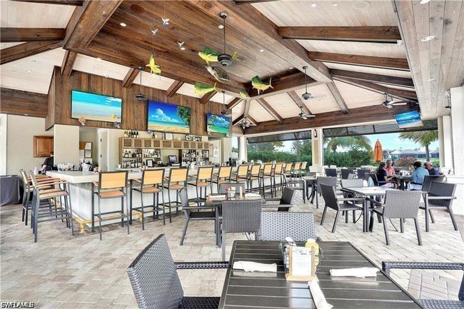 View of patio with ceiling fan, a bar, and a gazebo | Image 31