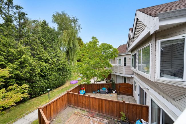 Wooden terrace with a fenced backyard | Image 27