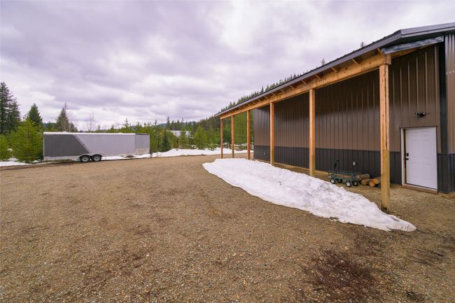 View of yard featuring an outbuilding and a pole building | Image 42