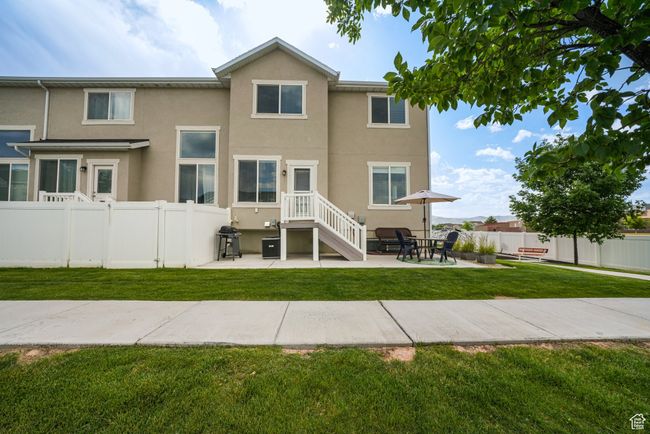 Rear view of house featuring stucco siding and a patio area | Image 32