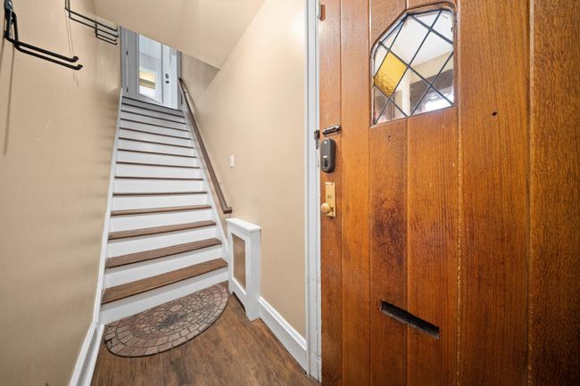 Staircase featuring wood finished floors and baseboards | Image 10