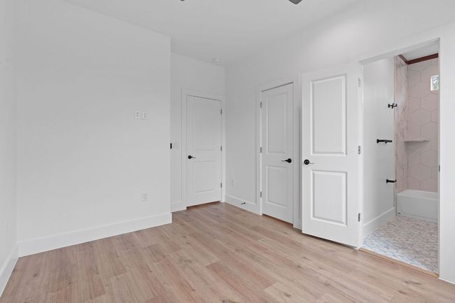 Unfurnished bedroom featuring light wood finished floors and baseboards | Image 22