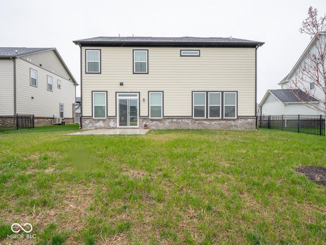 back of house featuring a yard, a fenced backyard, brick siding, and central air condition unit | Image 53