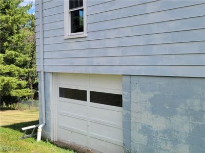 Garage featuring a yard | Image 3