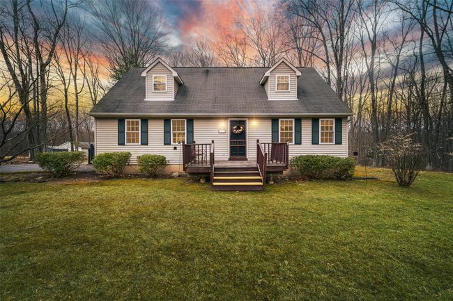 New england style home featuring a lawn and a deck | Image 41