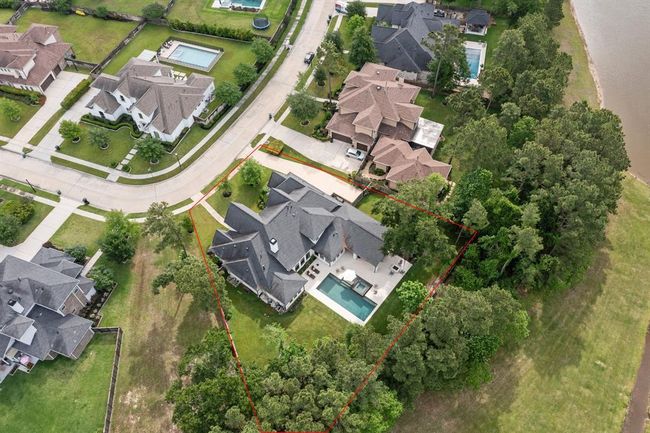 This nearly half-acre lot backs to a greenbelt with a tranquil landscape of trees and lakes! | Image 4
