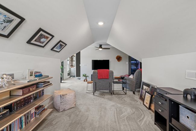 Sitting room featuring carpet, vaulted ceiling, and ceiling fan | Image 26