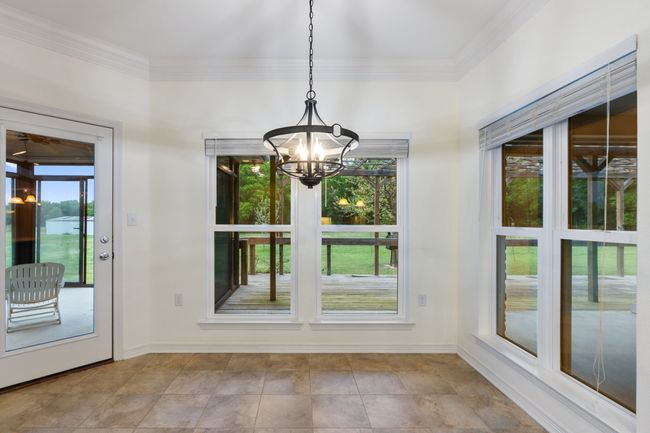 Doorway featuring a notable chandelier and baseboards | Image 9