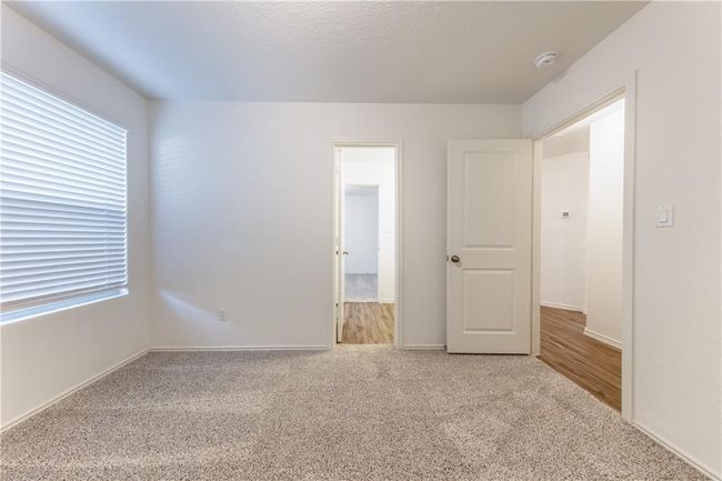Unfurnished bedroom featuring carpet and multiple windows | Image 17
