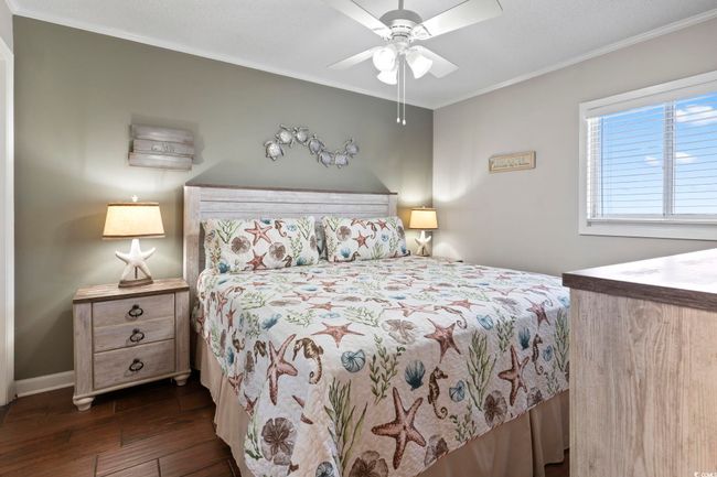 Bedroom featuring baseboards, dark wood-style flooring, ornamental molding, and ceiling fan | Image 6