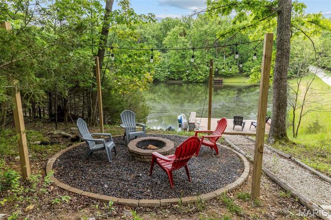 View of yard featuring a fire pit and a water view | Image 53
