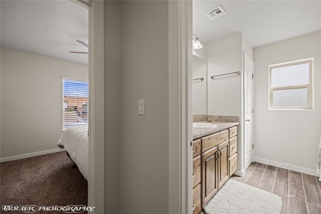 Bathroom featuring baseboards, vanity, ceiling fan, and wood finished floors | Image 12