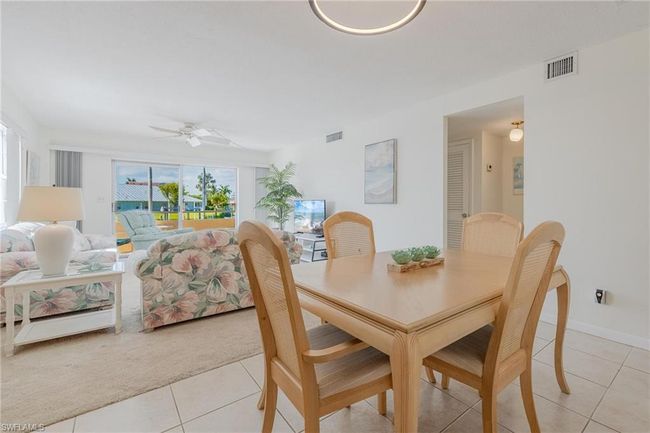 Dining room featuring ceiling fan and light tile floors | Image 13