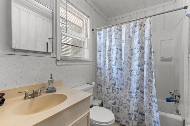 Bathroom with vanity, shower / bath combination with curtain, and ornamental molding | Image 36