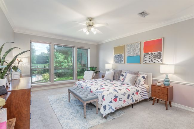 Spacious primary bedroom with view of the pool and golf course | Image 17
