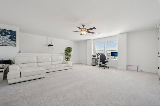 Living area featuring a desk, carpet, and a ceiling fan | Image 24
