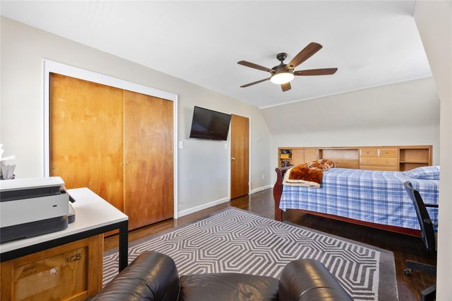 Bedroom featuring dark wood-style flooring, a closet, ceiling fan, baseboards, and lofted ceiling | Image 11