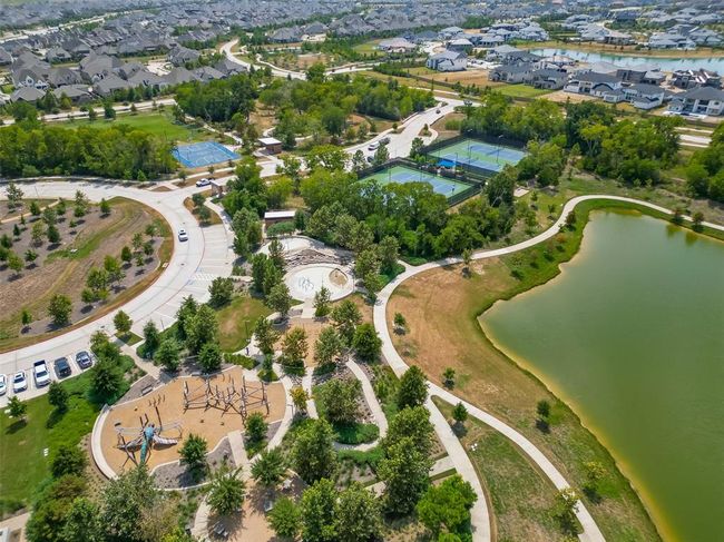 Features a single-family home with a spacious yard in Bridgeland, a master-planned community offering lakes, pools, sidewalks, and green spaces. | Image 29