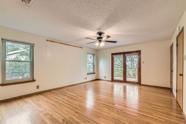 Spacious primary with wood floors opening off to upper deck | Image 13