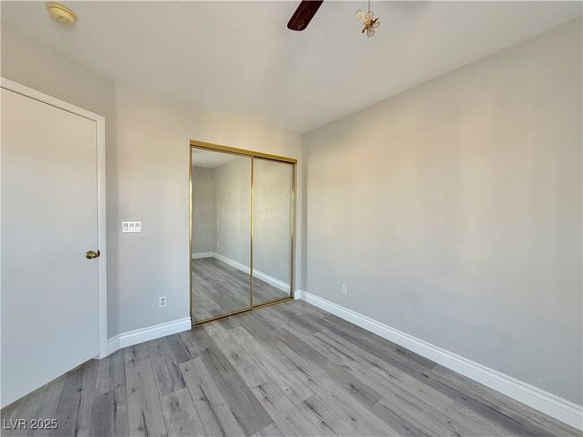Unfurnished bedroom featuring a closet, baseboards, and wood finished floors | Image 35
