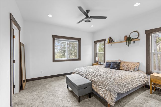 Carpeted bedroom with a ceiling fan, baseboards, recessed lighting, and multiple windows | Image 22