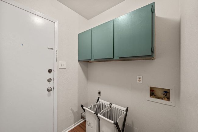 Laundry area fits a w/d side by side with additional cabinetry above for storage. | Image 15