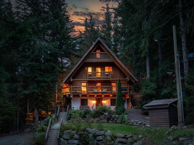 View of front of property with a balcony, an outdoor structure, stairway, log exterior, and a storage unit | Image 7