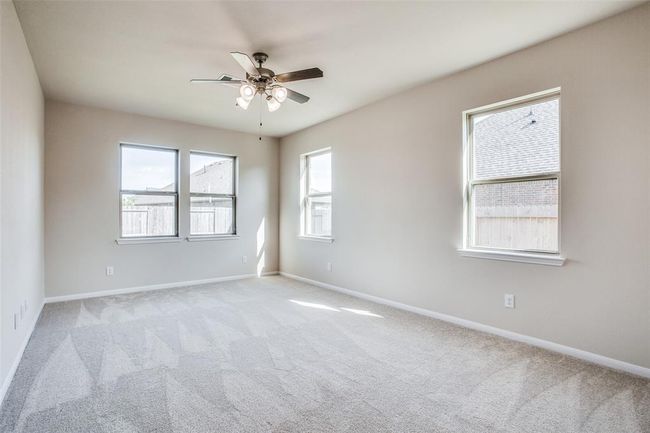 Primary Suite with ceiling fan located on the first floor | Image 13