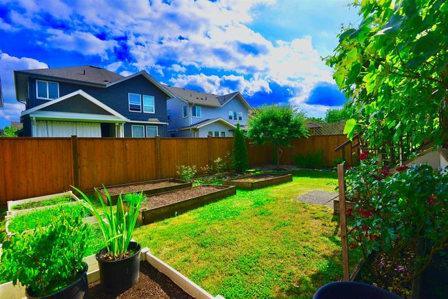 Fenced backyard featuring a garden | Image 37