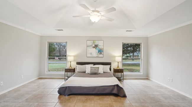 Bedroom with multiple windows, visible vents, and a tray ceiling | Image 24