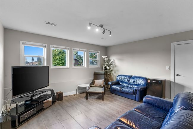 Tiled living area featuring baseboards | Image 22